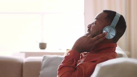 man listening to music on couch