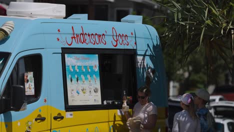 people buying ice cream from a truck