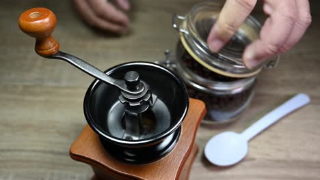 coffee grinder, jar with coffee beans, spoon