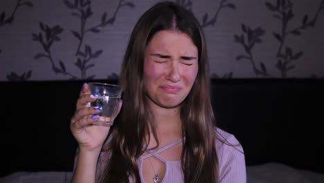 beautiful teenage girl drinking, tasting from the glass, discussed