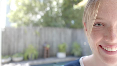 Portrait-of-happy-caucasian-woman-with-blond-hair-in-garden,-copy-space,-slow-motion