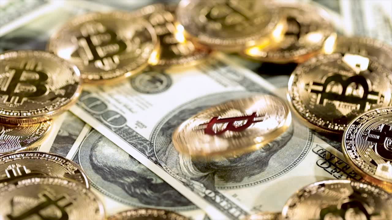 Gold Bit Coin BTC coins and dollar bills.