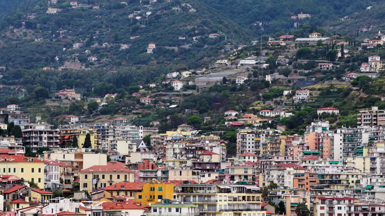 Aerial drone view of the Mediterranean coastal city of Sanremo with colorful buildings climbing the hillside on the Italian Riviera in Liguria, Italy