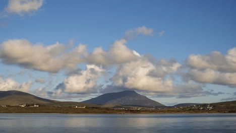 time lapse of clouds rolling over hills of a remote landscape on summer day in ireland