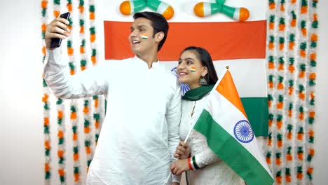 young indian teenagers clicking selfie together on republic day - national flag background