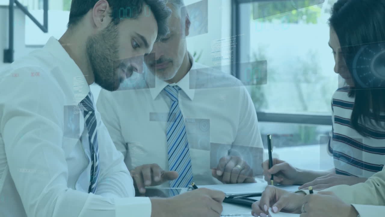 Business professionals collaborating at desk with digital data overlay animation