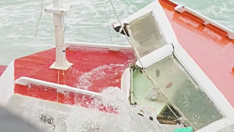 Close-up-of-local-wooden-fishing-boat-being-smashed-into-pieces-during-sudden-storm-with-rough-waves,-Caribbean