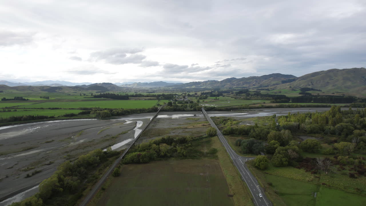 Aerial view following bridges on the Waiau river, cloudy day in New Zealand
