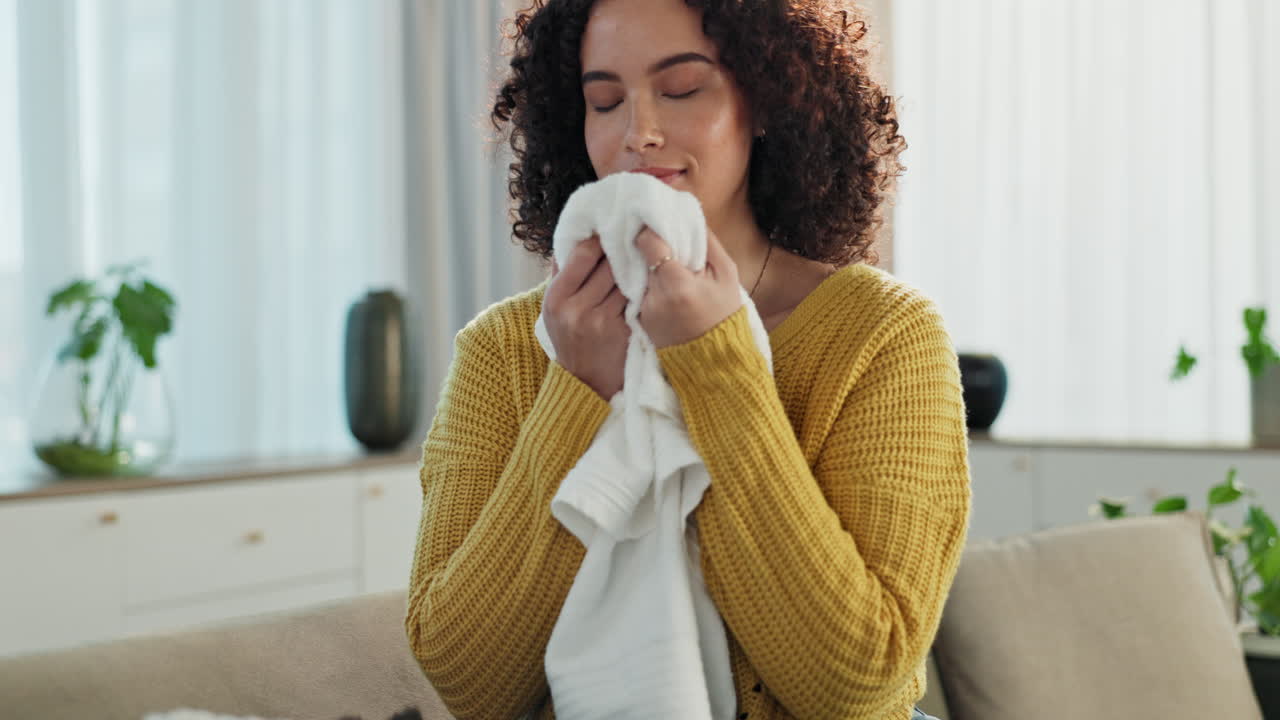 Woman smelling fresh clean towel