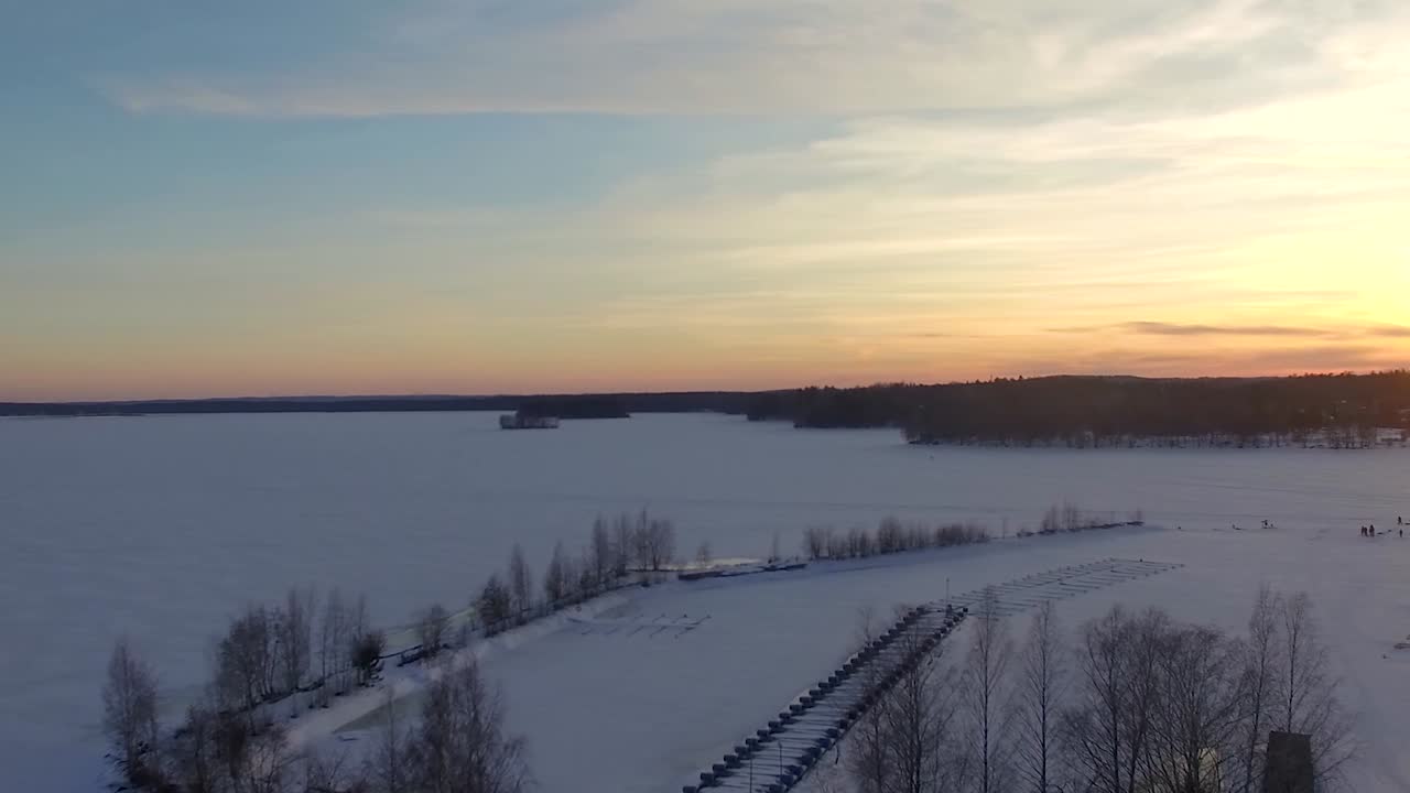 Aerial view of frozen lake Pirkanmaa, boat harbour and winter scenery of Nokia, Finland.