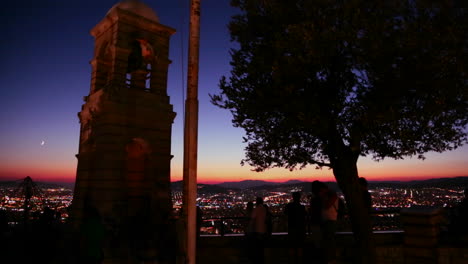 A-night-sunset-shot-over-a-busy-city-metropolis-with-a-Spanish-style-mission-building-in-the-foreground