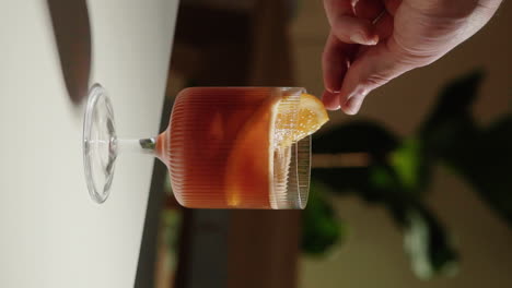 Video-Vertical-Colocando-Una-Rodaja-De-Naranja-Para-Decorar-Espresso-Tonic-En-Un-Hermoso-Vaso-Para-Beber-En-Casa