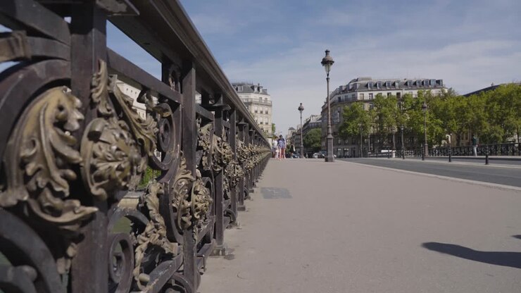 Low Angle View Of Pont Notre Dame Bridge Crossing River Seine In Paris France With Tourists