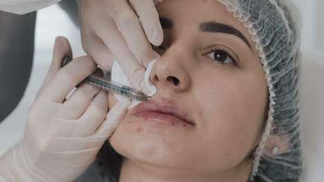 woman receiving lip filler injection in a beauty clinic