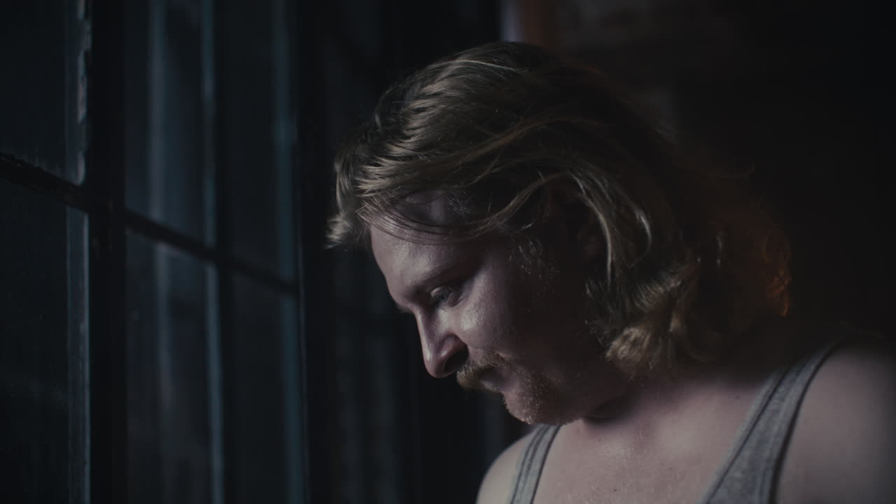 Man Looking Through a Window at Night