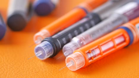 Collection-of-insulin-pens-on--background