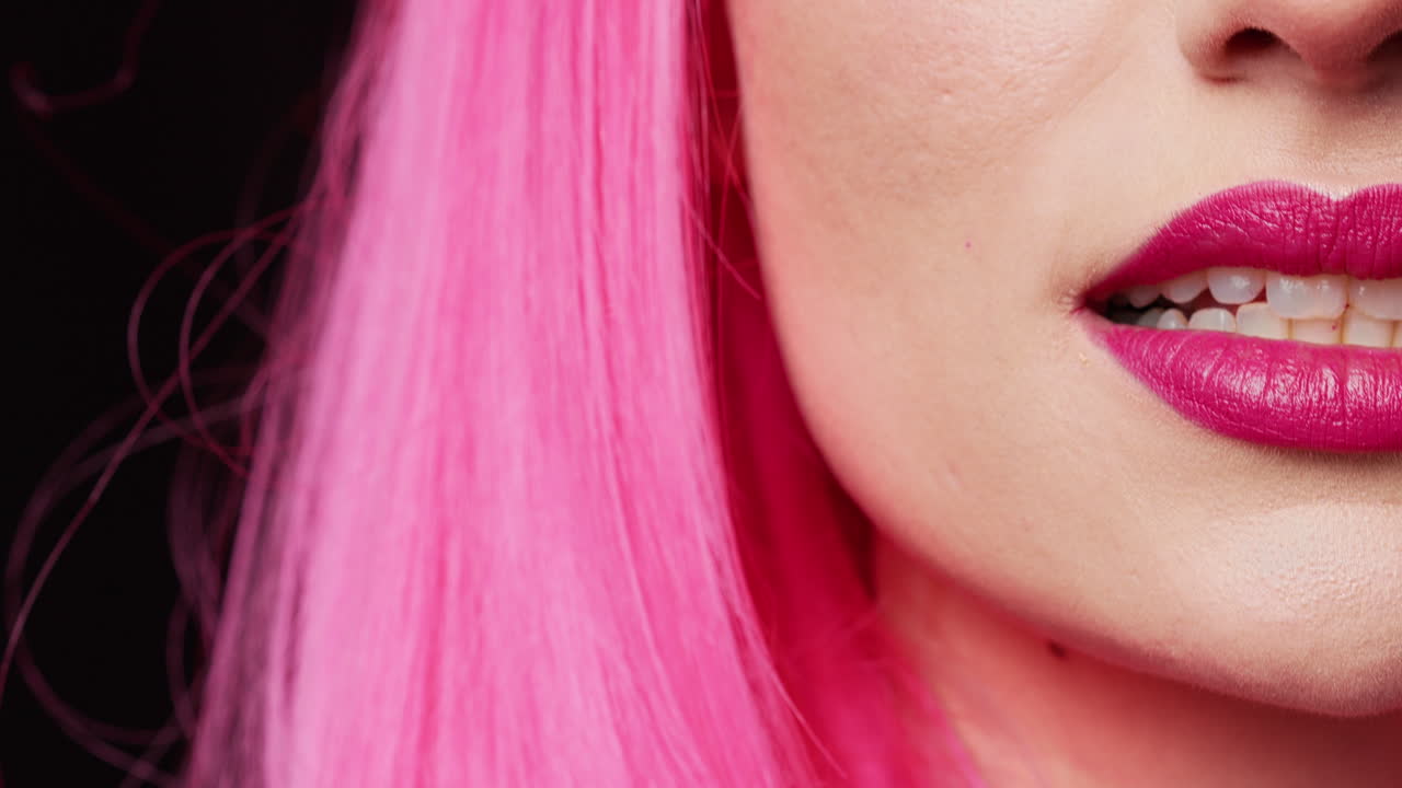 Beauty model with pink lipstick biting lips on camera