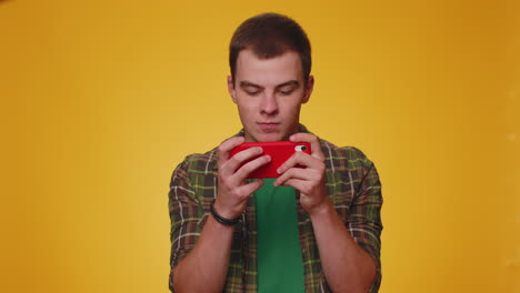 Worried-funny-addicted-tourist-boy-enthusiastically-playing-drive-racing-video-games-on-mobile-phone