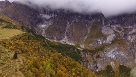 beautiful autumn fall mountain landscape, aerial drone view, cloudy peaks