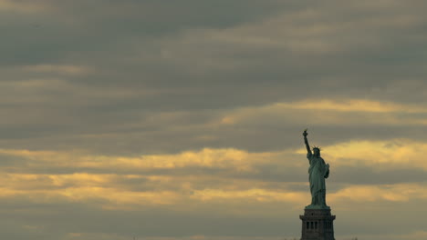 bold colored sky after sunset with statue of liberty