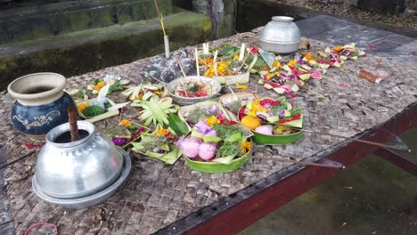 balinese offerings, elements of the priest, flowers, pots, incense, holy water, canang sari and ceremonial objects for praying and worshiping in bali, hindu religion, indonesia