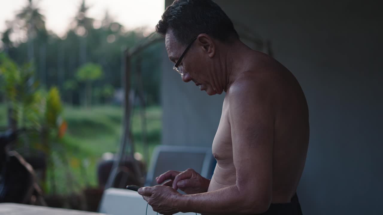 Older man using smartphone outdoors