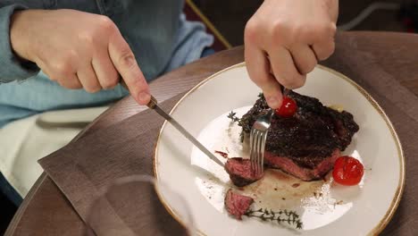 man eating steak in a restaurant