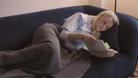 woman reading a book on the couch