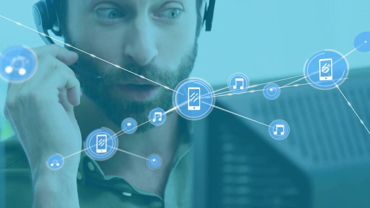 Man raising hand to headset and speaking at desk, phone icon causing telecom network routing audio
