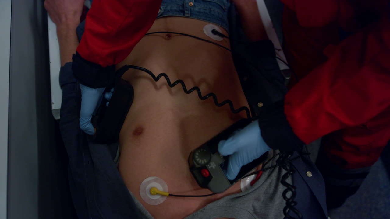 Emergency care doctor giving first aid help to man