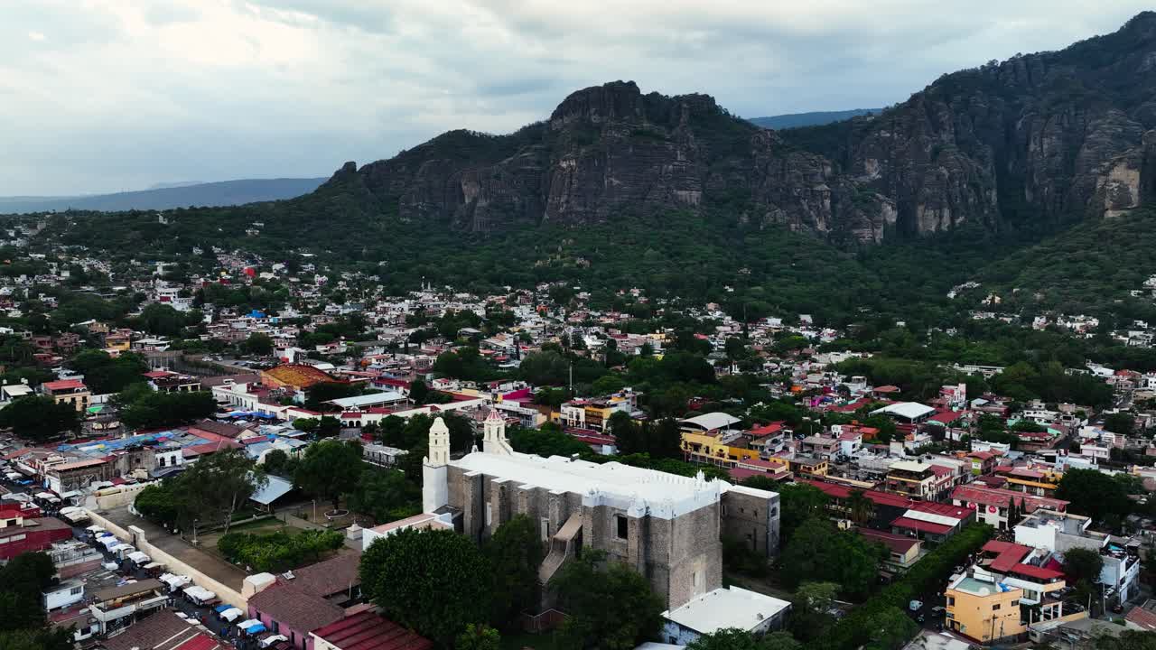 Drone shot in front of the Catedral de la Natividad de Nuestra Se&ntilde;ora in Tepoztlan, Morelos, cloudy Mexico
