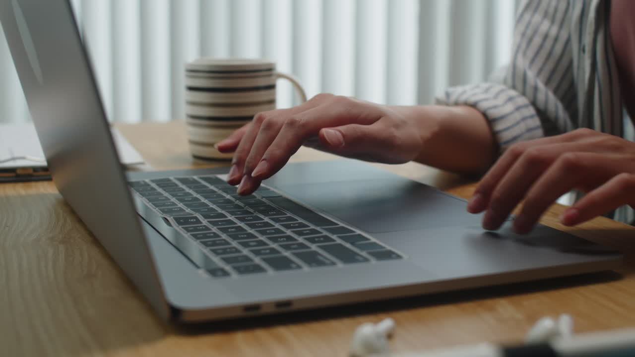 Hands of Businesswoman Typing on Laptop