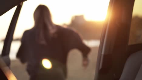 long haired woman came to the sea, running out from the car seat to the beach