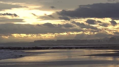 Puesta-De-Sol-Dorada-Con-Las-Olas-Acariciando-La-Costa