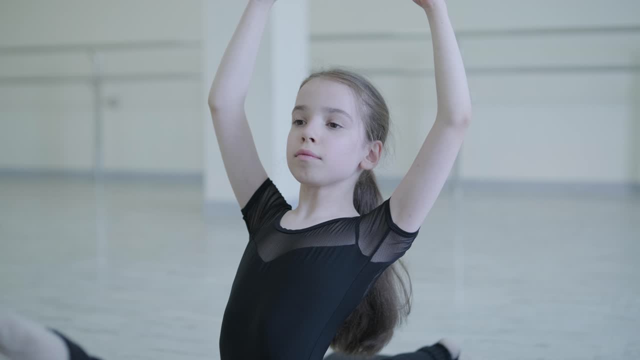 Young Ballerina Practicing Dance Moves in Studio
