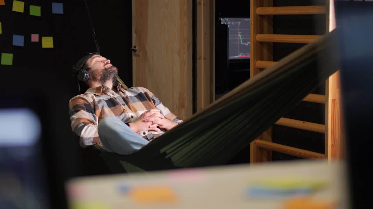 Static view of hipster over an amaca sleeping at work