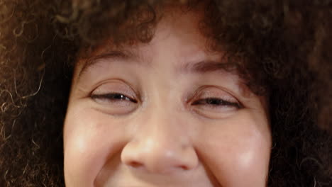 Portrait-of-smiling-casual-biracial-businesswoman-in-office,-slow-motion-with-copy-space