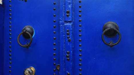 bright blue traditional door with metal details in an ancient tunisian city