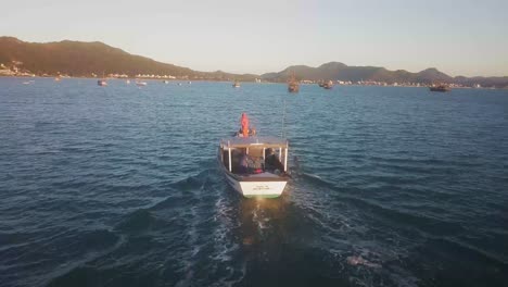 fishing boat traveling into beach on florianopolis, brazil