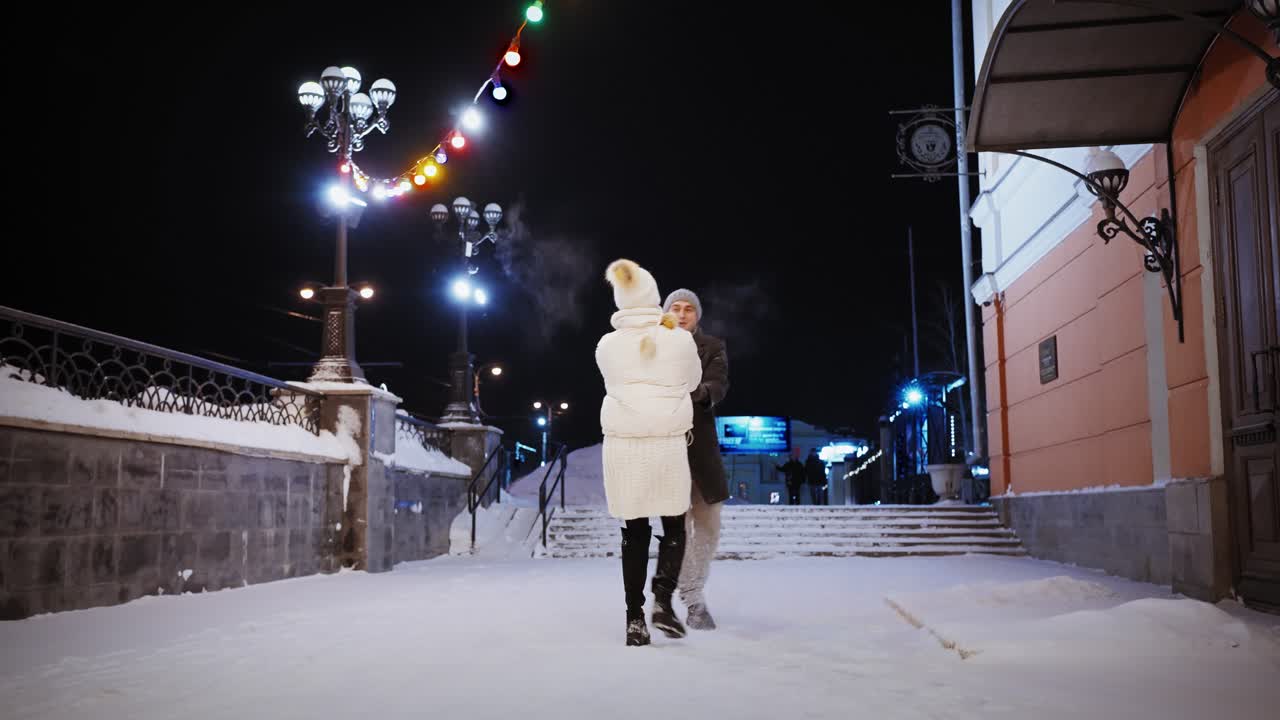 Couple Dancing in the Snow at Night