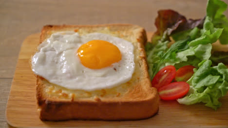 homemade-bread-toasted-with-cheese-and-fried-egg-on-top-with-vegetable-salad-for-breakfast