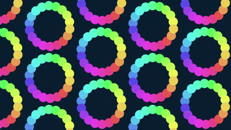 Rainbow-spiral-pattern-of-overlapping-circles-on-black-background