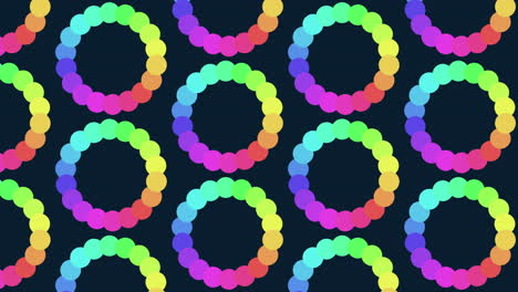 Rainbow spiral pattern of overlapping circles on black background