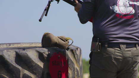 marksman with sniper rifle walks towards firing point