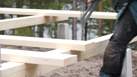 Contractor-craftsman-using-circular-saw-at-construction-site,-slow-motion-shot