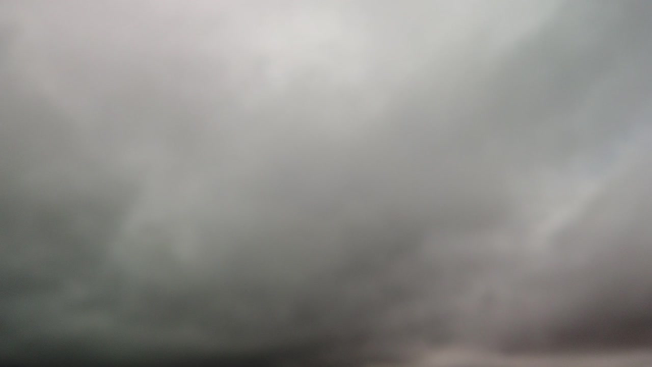 Rushing cloud hyperlapse of fog lifting in a mountainous region, dreary, bleak, gray