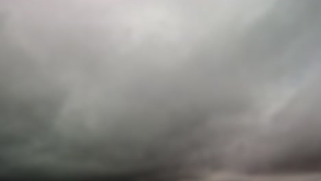 rushing cloud hyperlapse of fog lifting in a mountainous region, dreary, bleak, gray