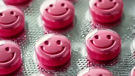 a close up of a pack of pills with smiley faces on them