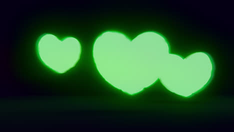 green energy heart shapes on a dark background