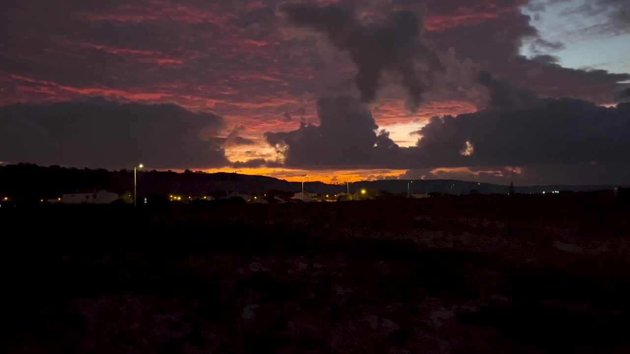 Sunset with dramatic clouds lighting up the sky in fiery colors. A tranquil and stunning way to end the day. Ideal for nature, romance, and serene moments.